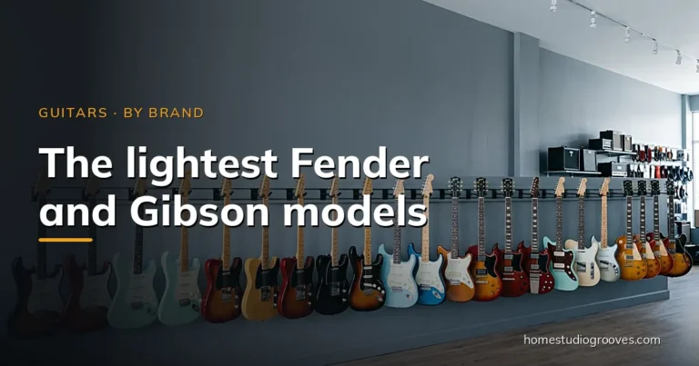 Row of Fender and Gibson electric guitars hanging on a grey guitar shop wall in daylight
