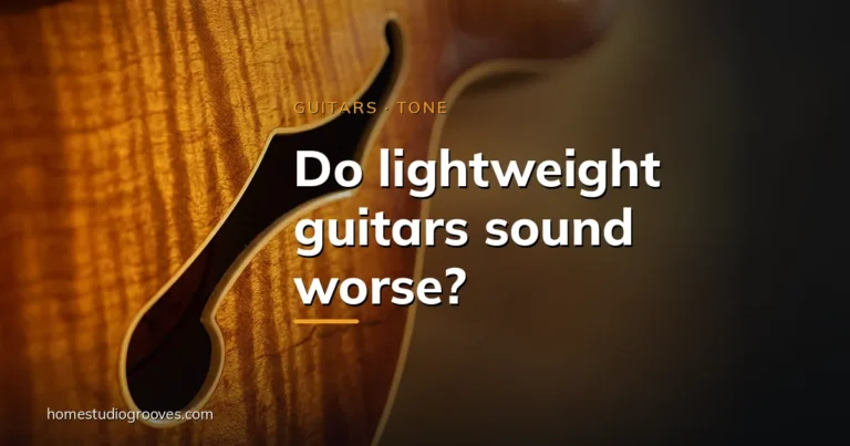 Close-up of the f-hole and amber flamed wood grain on a semi-hollow electric guitar body in warm light